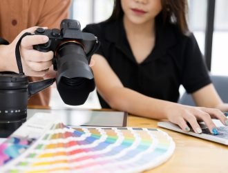 Photo artist and graphic desginer selecting pictures from camera.
